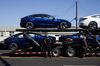Workers unload Tesla Inc. Model 3 electric vehicles from a car carrier outside the company's delivery center in Marina Del Rey, California, U.S., on Saturday, Sept. 29, 2018. Tesla brought the total number of Model 3 produced in the third quarter to over 51,000 vehicles.