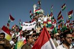 Supporters wave flags during a rally for the referendum for independence of Kurdistan in Erbil, Iraq, on Sept. 22, 2017.
