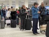 Passengers queue for check in at Manchester Airport's terminal 1 ahead of the Easter weekend.&nbsp;