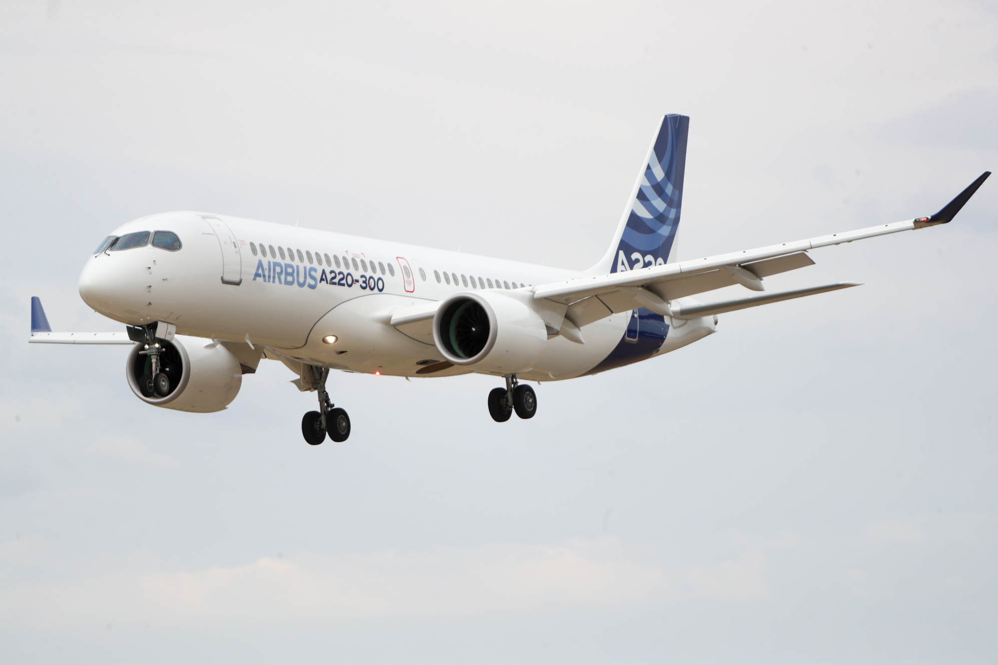 An Airbus SE A220-300 plane performs during the flying display on the opening day of the Farnborough International Airshow.