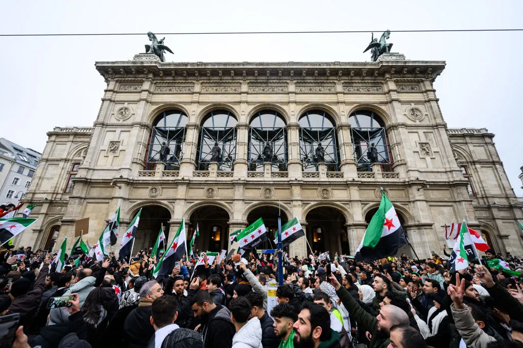 Members of the Syrian community wave Syrian flags on Dec.&nbsp;8.