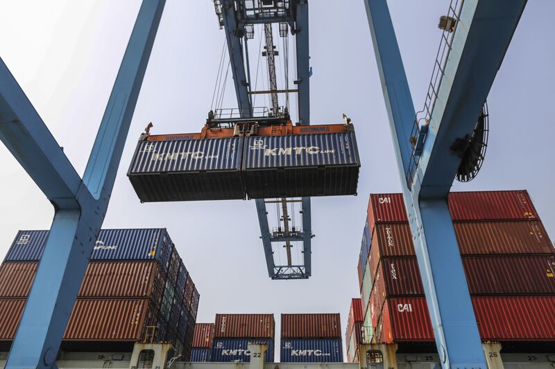 A gantry crane loads a shipping container onto a truck in Navi Mumbai, Maharashtra, India.