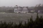 Waves crash around a home as Hurricane Irene arrives on August 28, 2011 in Southampton, New York. 