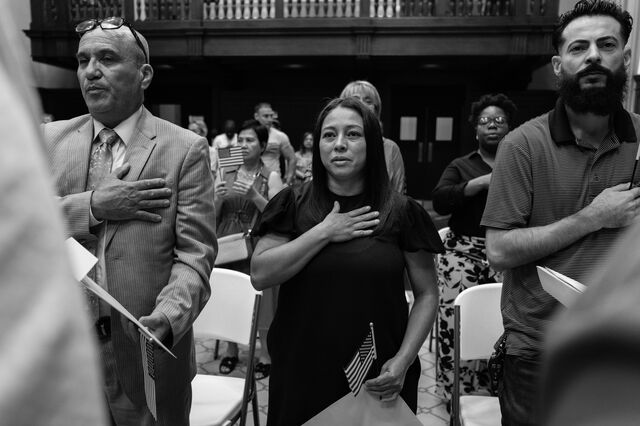 Rocio Nunez, middle, a new citizen from Mexico, recites the pledge of allegiance with other new citizens during their naturalization ceremony at the US District Court in Columbus, Georgia, in September 2024.