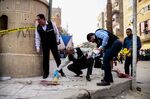 Egyptian security members and forensic police inspect the site of a gun attack outside a church south of the capital Cairo, on Dec. 29, 2017. =