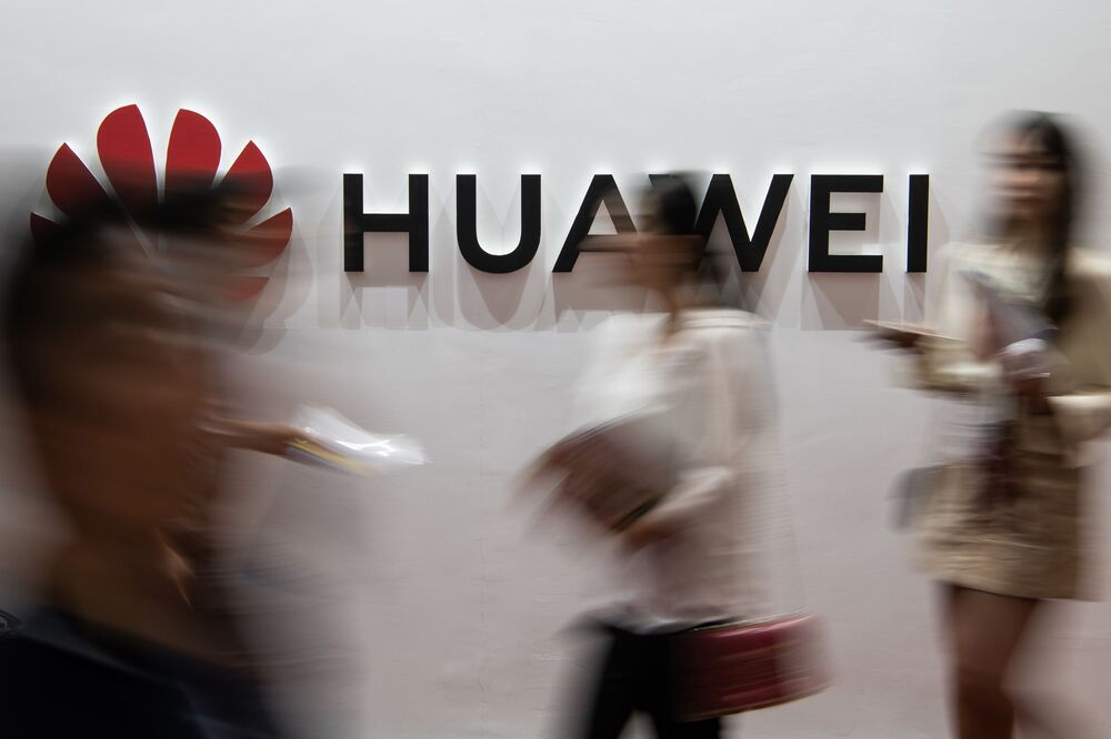 People walk past a Huawei logo during the Consumer Electronics Expo in Beijing on August 2, 2019. (Photo by FRED DUFOUR / AFP) (Photo credit should read FRED DUFOUR/AFP/Getty Images)