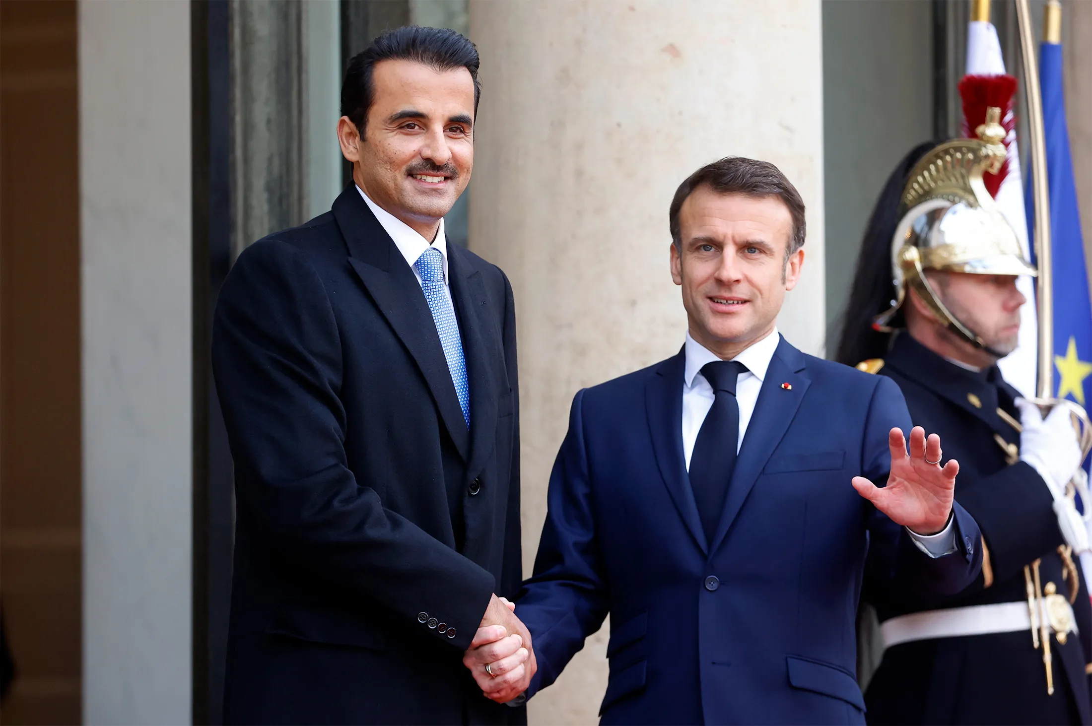 France's President Emmanuel Macron, right, welcomes Qatar's Emir Sheikh Tamim Bin Hamad Al Thani&nbsp;at the Presidential Elysee Palace&nbsp;in Paris on Feb. 27.