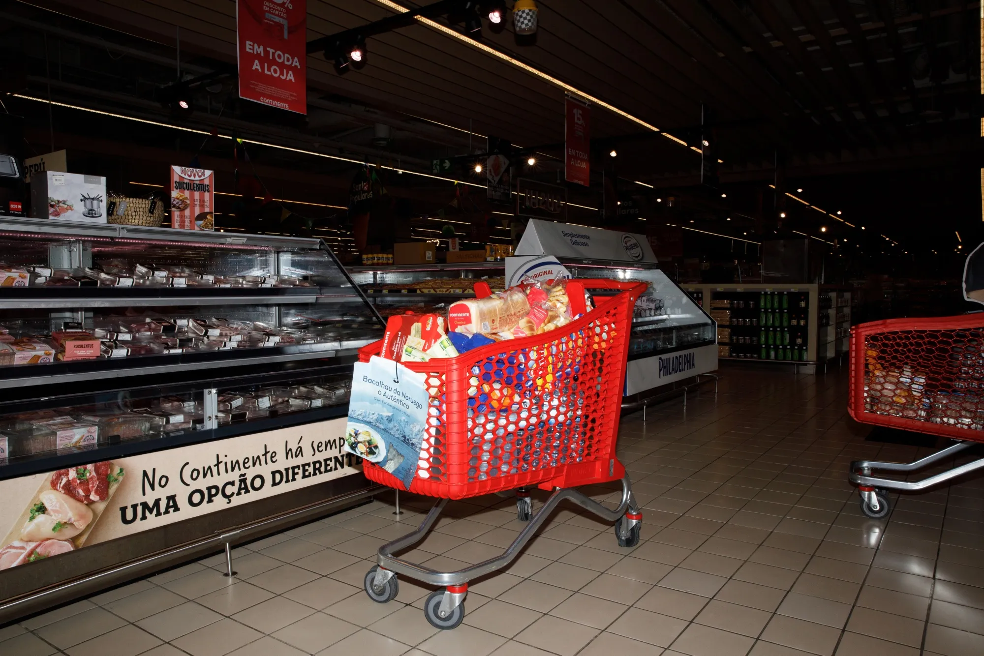 A shopping cart filled with food products inside a Continente supermarket at the Colombo shopping mall in Lisbon, Portugal.