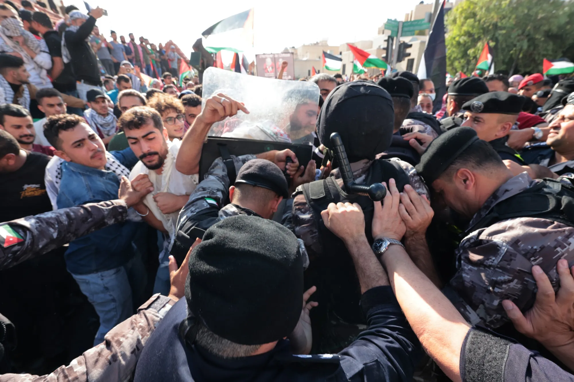 Jordanian anti-riot police clash with protesters outside the Israeli embassy on Oct. 18 in Amman, Jordan.