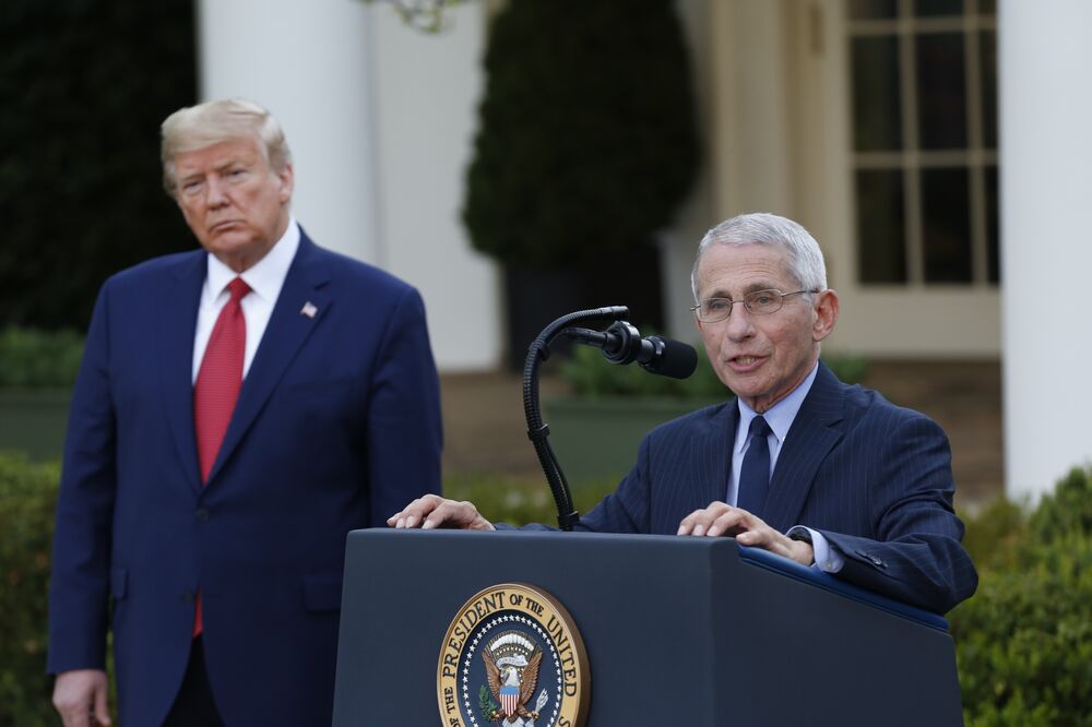 Anthony Fauci, director of the National Institute of Allergy and Infectious Diseases, right, speaks as U.S. President Donald Trump listens.