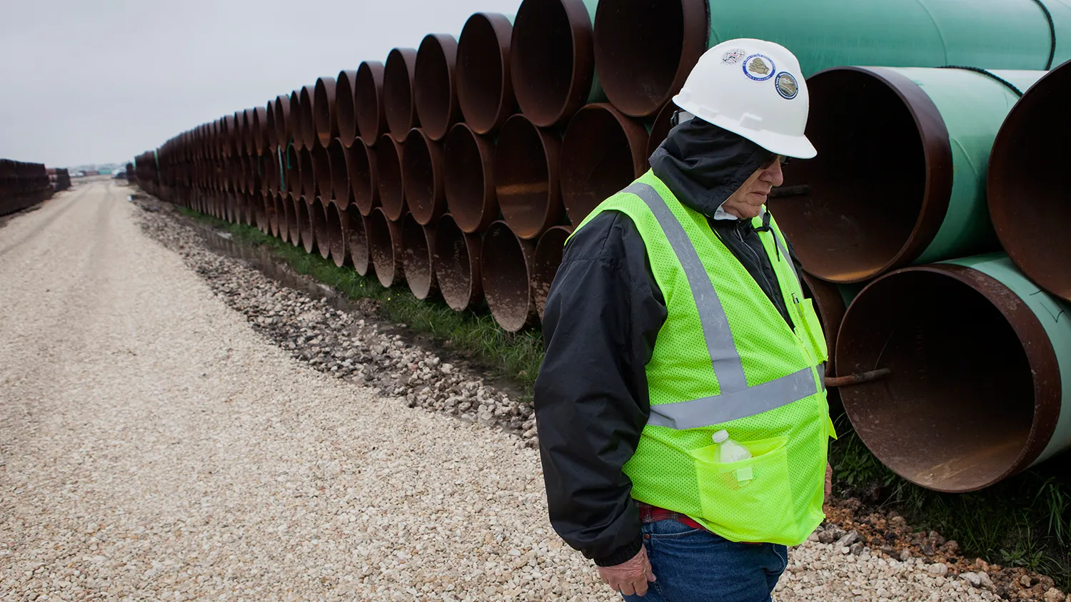 A worker walks through the TransCanada Corp. Houston Lateral Project pipe yard in Mont Belvieu, Texas, U.S., on Wednesday, March 5, 2014. Russ Girling, TransCanada Corp. president and chief executive officer, said he remains "optimistic" that market forces will see that the embattled Keystone XL oil sands pipeline is built, but the real question is when.
