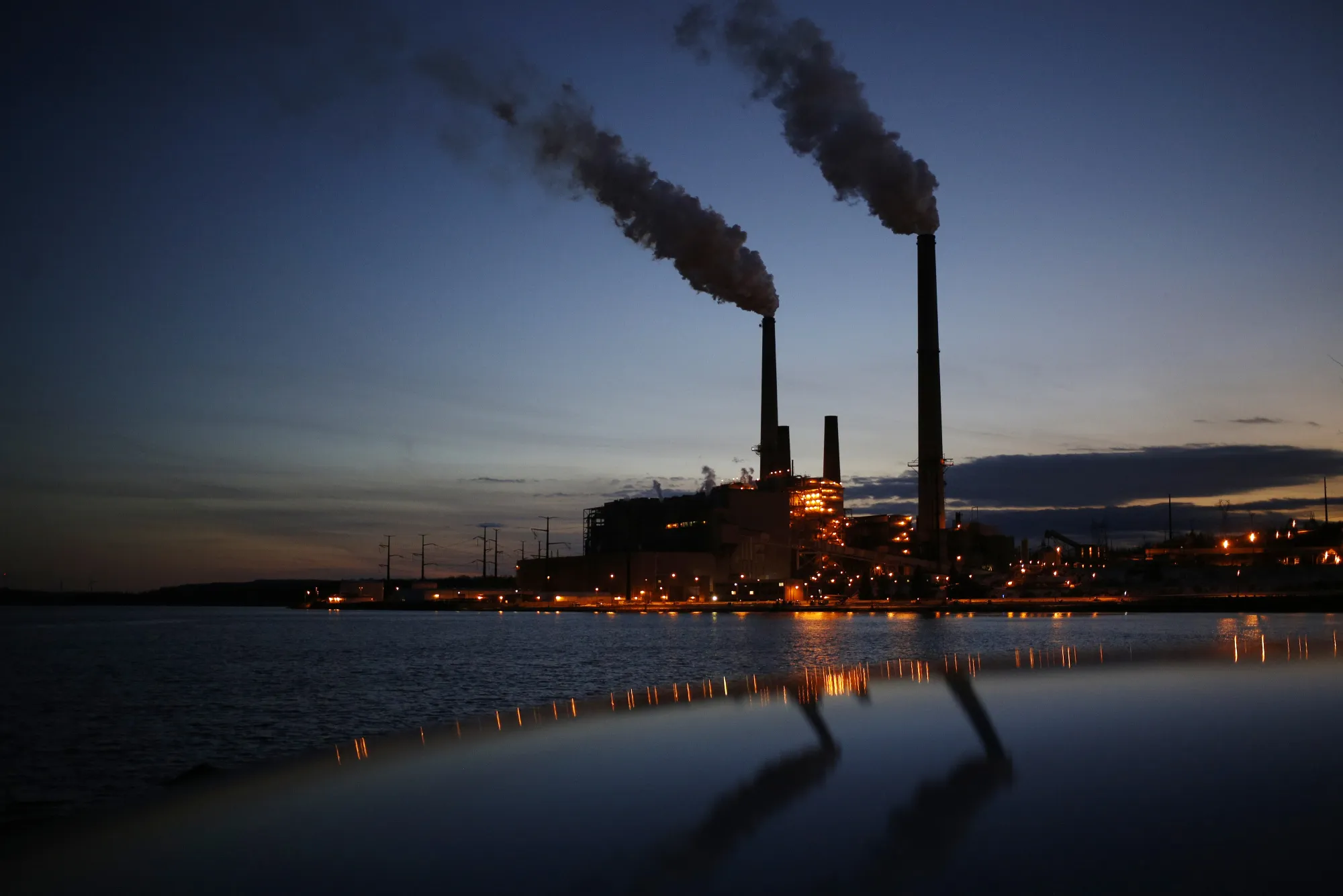 The Dominion Resources Inc. Mount Storm Generating Station stands illuminated at dusk in Mount Storm, West Virginia.