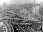 An aerial view of Los Angeles shows the complex of freeways, new construction, familiar landmarks, and smog in 1962.