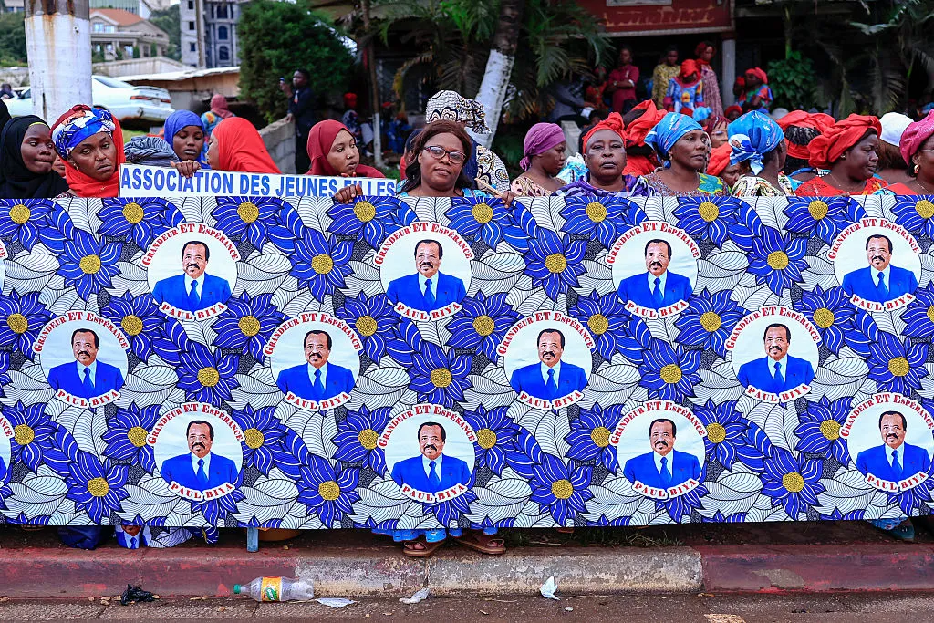 Supporters&nbsp;hold a campaign fabric bearings the image of Paul Biya, in Yaounde.