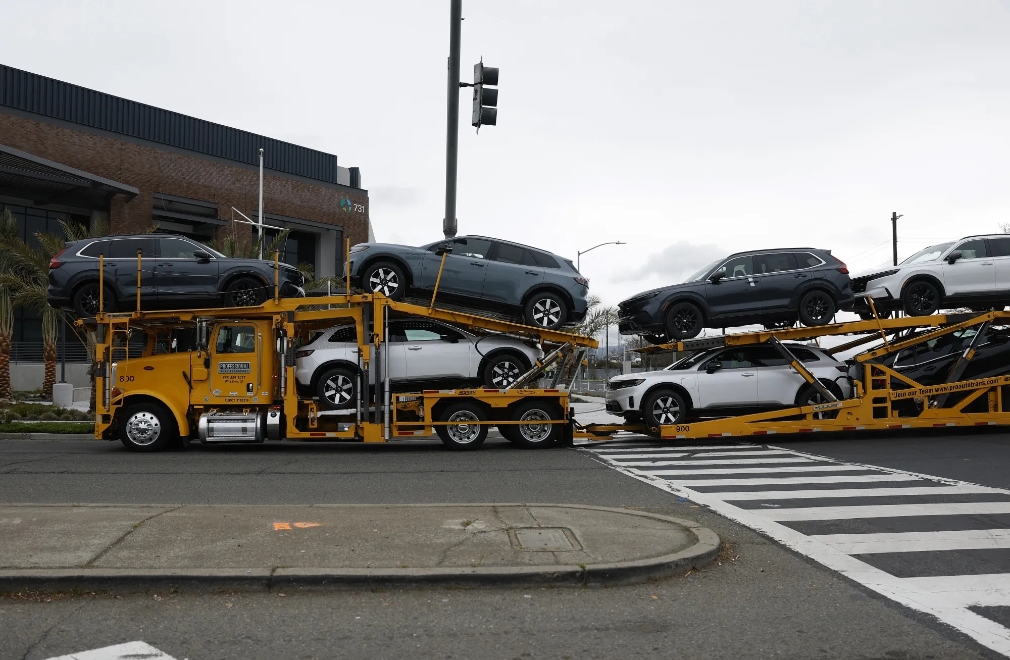 A truck carries brand new cars in Richmond, California.