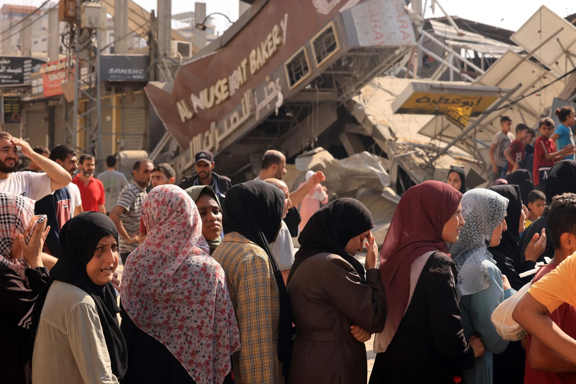 People queue for bread in front of a partially destroyed bakery&nbsp;in Gaza on Nov.&nbsp;2.