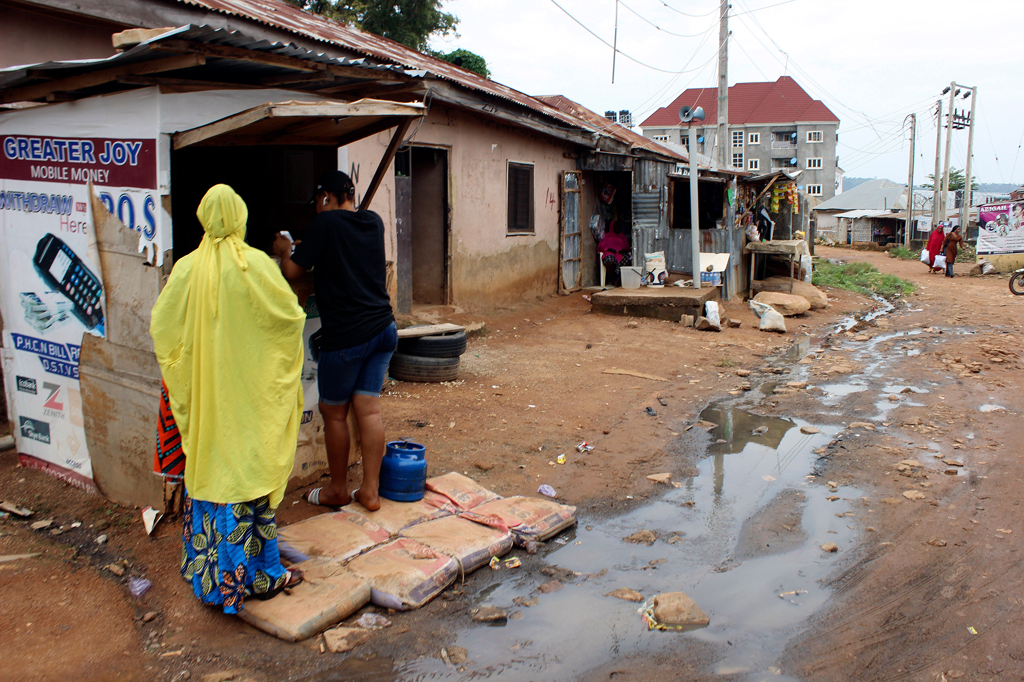 Sewage water runs past a stall in Abuja, Nigeria, on Sept. 3.