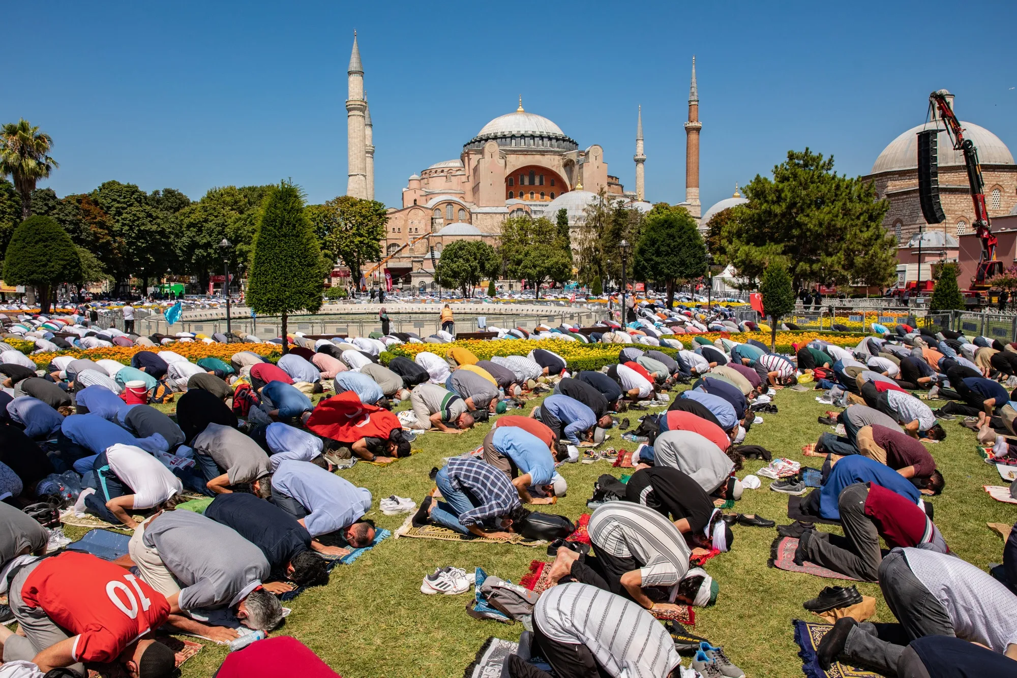 Worshipers pray outside during the opening ceremony to mark the first day of prayers at the Hagia Sophia mosque, in Istanbul, on July 24.