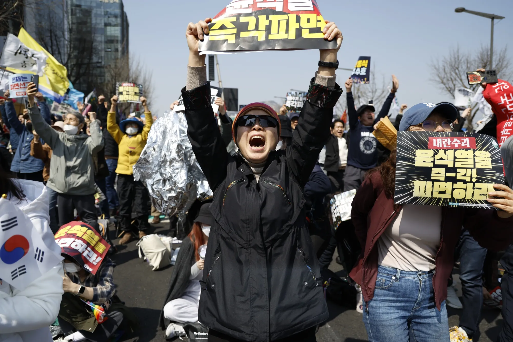 Protesters react in Seoul after the Constitutional Court ruled to remove Yoon from office.