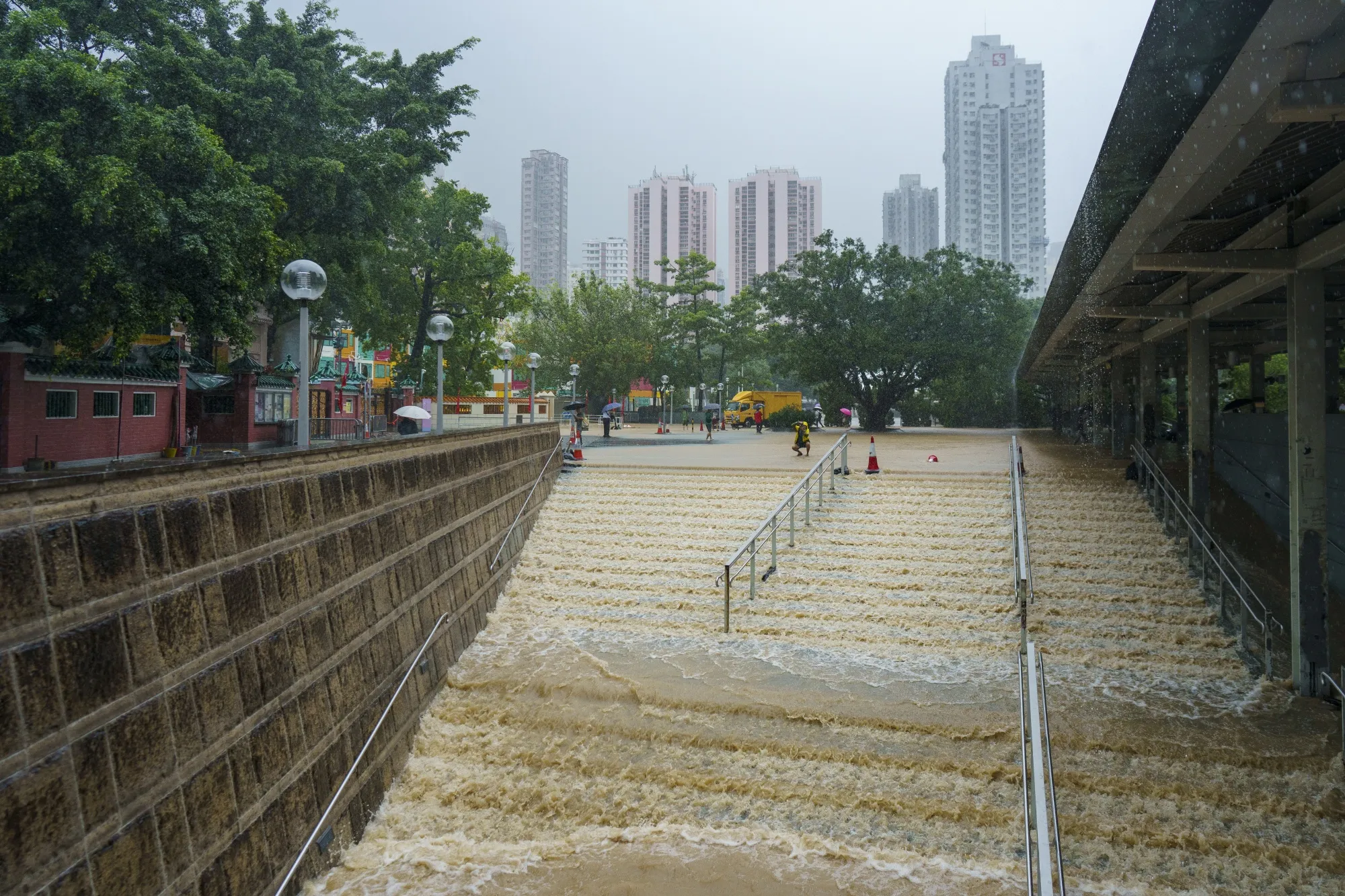 Torrential rain turns flights of steps into treacherous torrents across the city.
