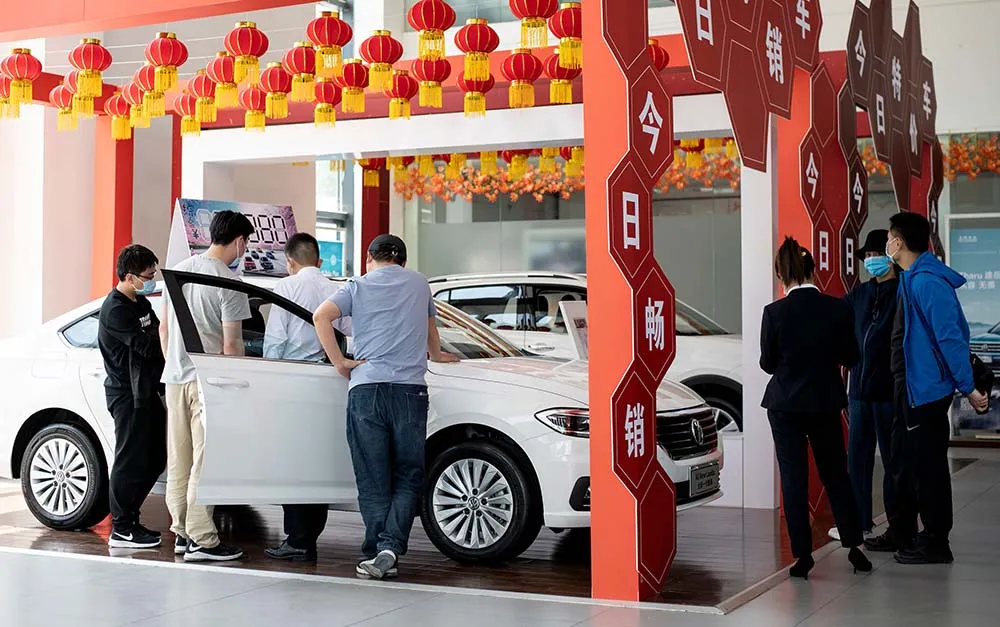 Customers browse vehicles for sale&nbsp;at a showroom in Beijing in June.