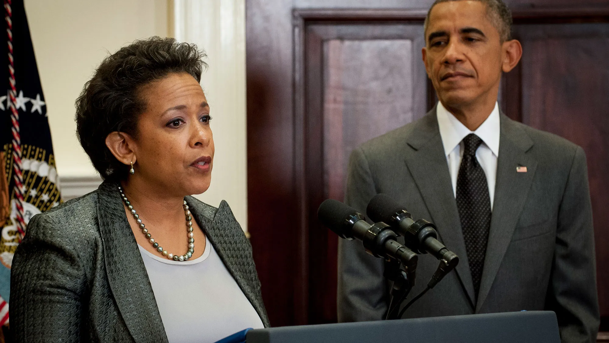 U.S. President Barack Obama listens as Loretta Lynch, Brooklyn prosecutor, speaks in the Roosevelt Room of the West Wing of the White House in Washington, D.C., U.S., on Saturday, Nov. 8, 2014.
