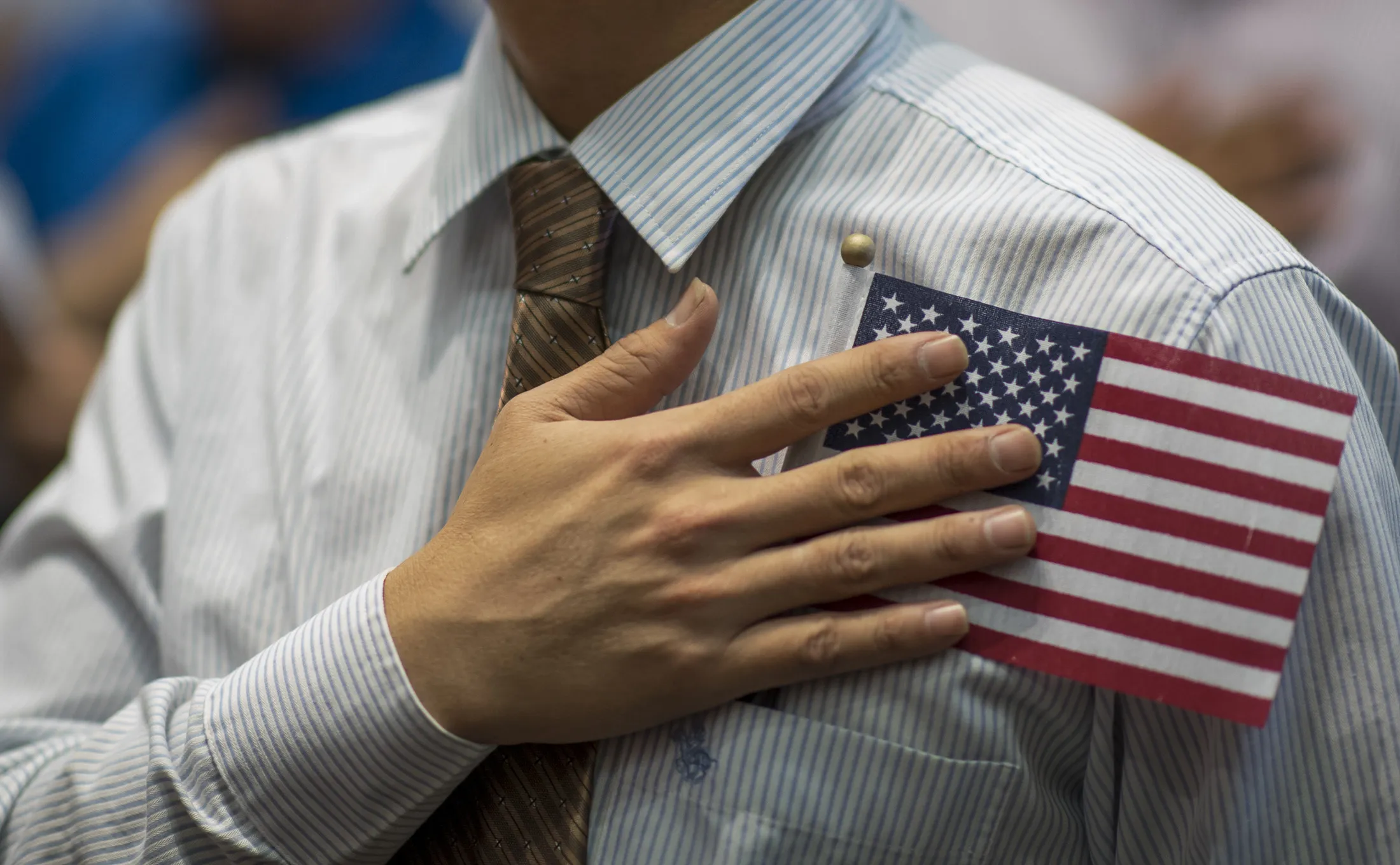 An applicant for U.S. citizenship recites the Pledge of Allegiance during a naturalization ceremony in Tucson, Arizona.
