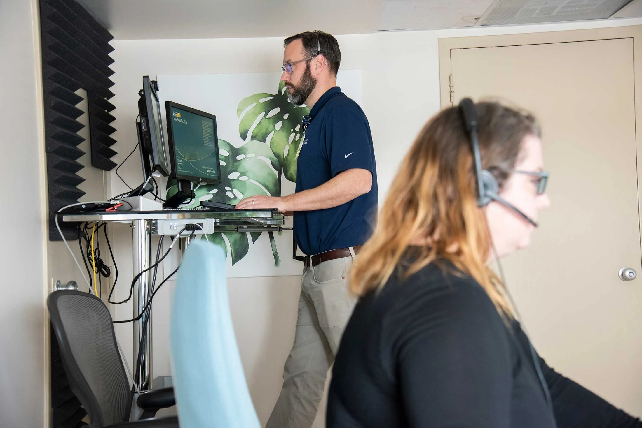 Working in a remote command center, Ethan Booker (left) and Kirsten Sheahan, both attending physicians, interview and assess patients over video chat as part of the MedStar Health Emergency Department’s TeleTriage program.&nbsp;
