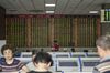 Investors stand at trading terminals in front of an electronic stock board at a securities brokerage in Shanghai, China, on Wednesday, May 30, 2018. Foreign investors are about to get a bargain. At least, that's the optimistic slant after Chinese equities slumped for the longest stretch since 2013, taking valuations back to two-year lows right before they feature on MSCI Inc. indexes from June 1.