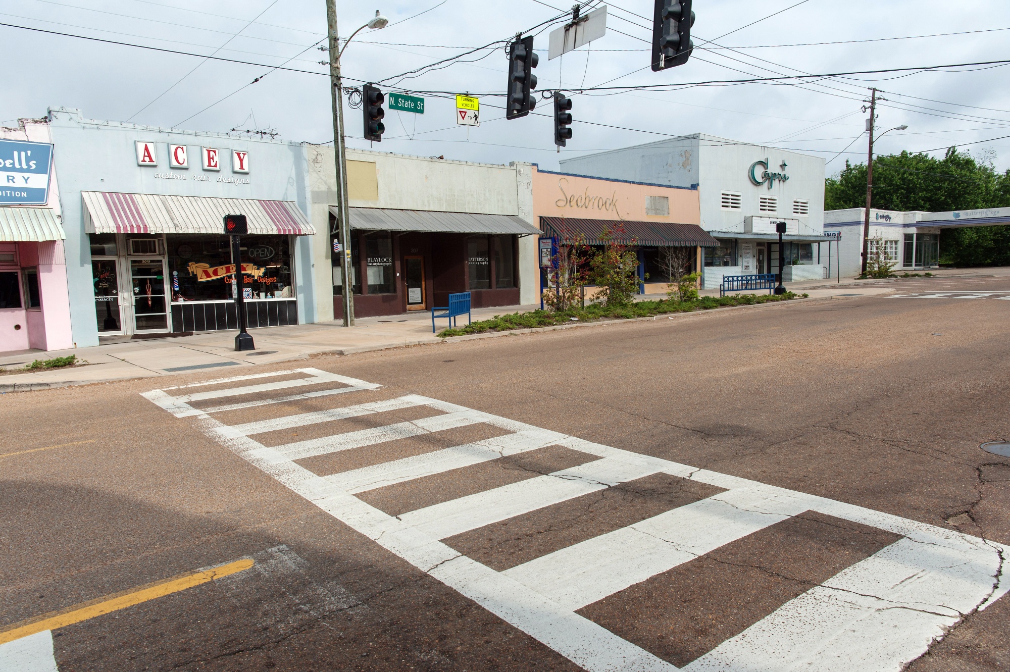 An empty street is seen in front of closed stores in the Fondren District of Jackson, Mississippi, U.S.