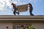 Engineers from Holaluz-Clidom SA prepare a residential solar panel installation in Toledo, Spain.