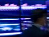 A trader walks past the board while working on the floor of the New York Stock Exchange in New York, U.S., on Tuesday, May 25, 2010. Stocks plunged from Tokyo to London and New York, dragging the MSCI World Index to a nine-month low, and commodities slid as concern grew that Spain's ailing banks signal a widening debt crisis and as tension mounted on the Korean peninsula. The German bund yield fell to its lowest since at least 1990.