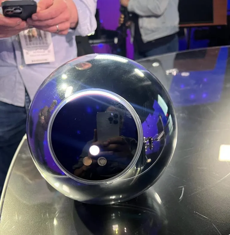 A Worldcoin orb on the Odd Lots set.