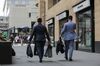 Men carry bags and suit carriers as they leave the offices of Deutsche Bank AG in London, U.K., on Monday, July 8, 2019. Deutsche Bank announced a sweeping turnaround plan that will transform Germany's biggest bank, with Chief Executive Officer Christian Sewing radically shrinking and reshaping its global operations.