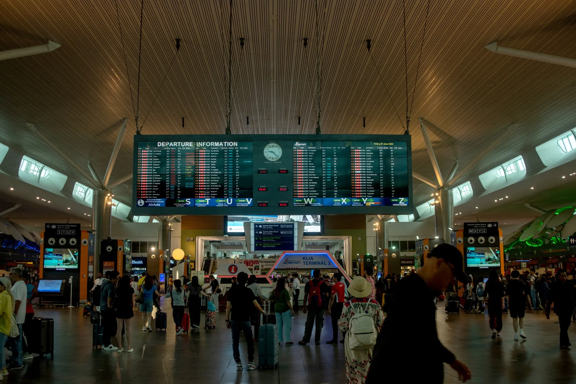 Passengers check flight details in the departure hall of the Kuala Lumpur International Airport 2 (KLIA 2) in Sepang, Malaysia.