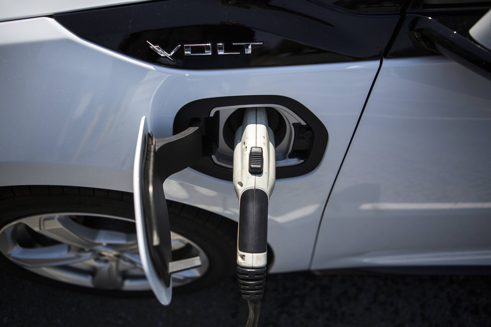 A ClipperCreek Inc. charging plug is seen connected to a&nbsp;Chevrolet Volt electric vehicle (EV) at a charging station in Los Angeles.